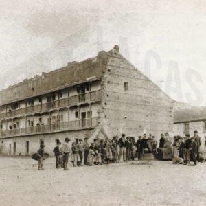 Antigua Casa del Barco y varias personas haciendo cola para coger agua de la fuente.