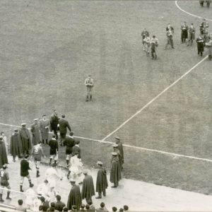 Entrada de los  jugadores al césped del Estadio Santiago Bernabéu en Madrid flanqueados por fuerzas del orden.