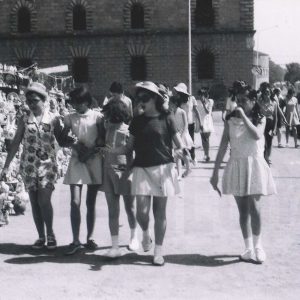 Mujeres jóvenes paseando frente  a puestos de cerámica