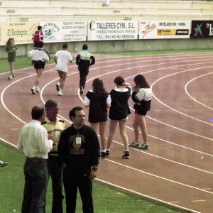 Varios deportistas y otras personas en las pistas de atletismo del Estadio Municipal El Deleite en Aranjuez