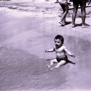 Niño sentado en la orilla del mar en Calpe