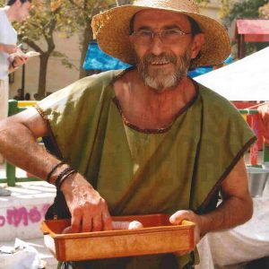 Un hombre disfrazado en un puesto de la Feria Goyesca de Artesanía en Aranjuez