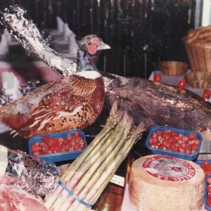Un faisán disecado, un jamón y otros productos en un restaurante en Aranjuez