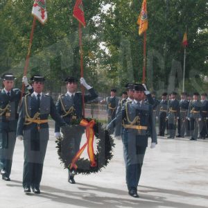 Varios guardias civiles portando una corona de laurel y estandartes durante la celebración de su Patrona en la Academia de Oficiales de Aranjuez